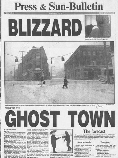 Front page of a newspaper, with the text Blizzard in large print above an image of someone standing in the street with a shovel, surrounded by snow. Beneath the image is the text Ghost Town, in large print as well.