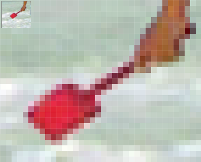 Close-up of the shovel held by the girl in the beach image we've been working on, zoomed in closely to show the individual squares of color that make up the image.